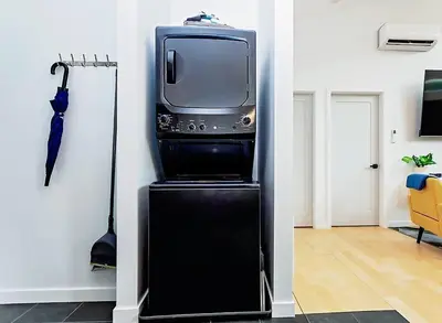 a television sitting on top of a black refrigerator at LuxQuarters Huckleberry Suite in Kitimat