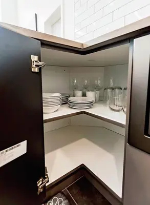 a open cabinet with plates and dishes on it at LuxQuarters Huckleberry Suite in Kitimat