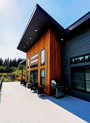 a building with chairs sitting outside of it at LuxQuarters Blueberry Studio in Kitimat