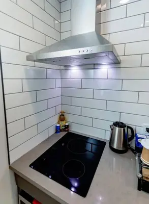 a kitchen with a stove top in a kitchen at LuxQuarters Blueberry Studio in Kitimat