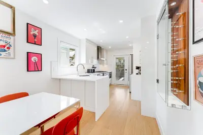 a kitchen with white counters and a white counter top at Riley Park-Modern 4 Bedroom Home, Central location in Vancouver