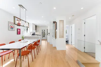 a kitchen and dining room with a table and chairs at Riley Park-Modern 4 Bedroom Home, Central location in Vancouver