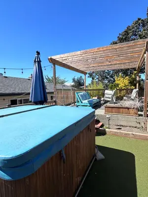 a pool table with an umbrella and a pergola at Frankies Westshore Hideaway in Victoria