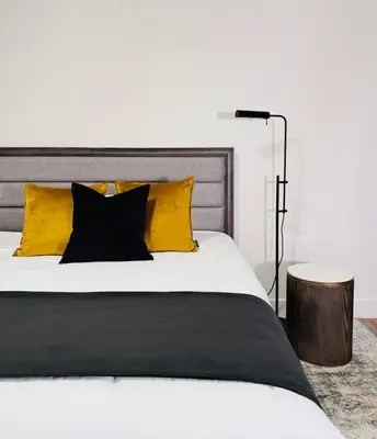 a bedroom with a white bed with yellow pillows at Modern King Room Private Ensuite Vancouver West in Vancouver