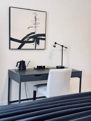 a desk with a white chair and a lamp at Modern King Room Private Ensuite Vancouver West in Vancouver