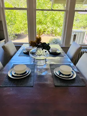 a dining room table with a blue table cloth and chairs at Modern King Room Private Ensuite Vancouver West in Vancouver