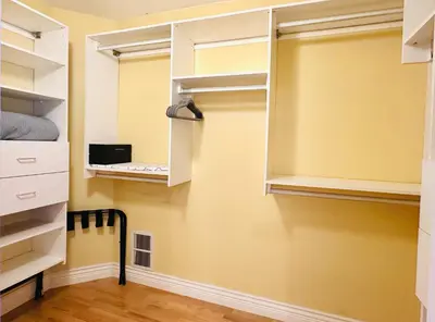 a walk in closet with white cabinets at Spacious 5BR 3BA Guest Villa - 10 Min to DT - Pet Friendly, Free Parking in Vancouver