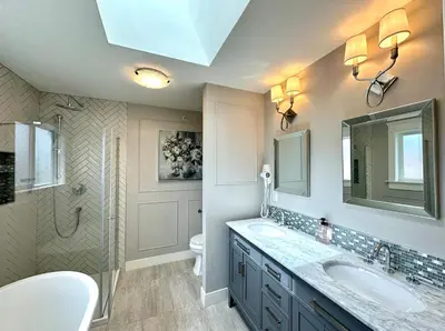 a bathroom with two sinks and a shower and a toilet at Spacious 5BR 3BA Guest Villa - 10 Min to DT - Pet Friendly, Free Parking in Vancouver