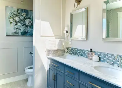 a bathroom with a sink and a mirror and a toilet at Spacious 5BR 3BA Guest Villa - 10 Min to DT - Pet Friendly, Free Parking in Vancouver