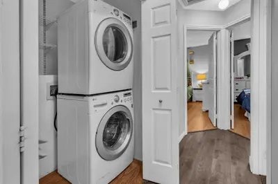 a white laundry room with a washer and dryer at 33 Executive Home, Ac, Airport in Calgary