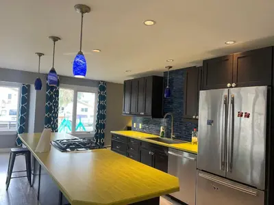 a kitchen with a stainless steel refrigerator and a counter at Little Holiday Home in Yellowknife