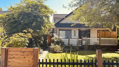 a house with a fence in front of it at Airport-YVR GuestHouse in Richmond