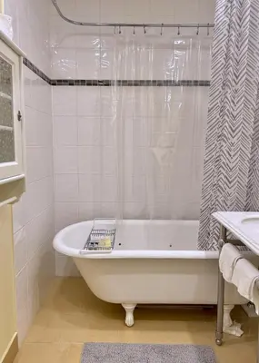 a white bathroom with a tub and a shower at Airport-YVR GuestHouse in Richmond