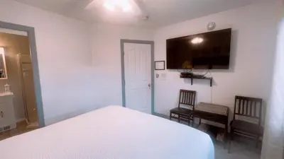a bedroom with a bed and a tv on the wall at Cornerstone Bed and Breakfast in Revelstoke