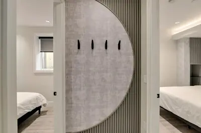 a bathroom with a large circular mirror on the wall at Designer 2BR in Downtown Steps from Sunset Beach in Vancouver