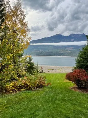 a view of a beach with a mountain in the background at Michaud's Basement unit in Nakusp
