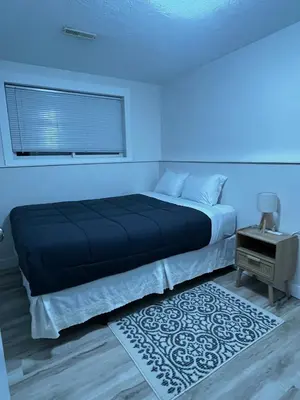 a bedroom with a bed with a blue light at Michaud's Basement unit in Nakusp