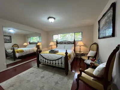 a bedroom with a bed and a chair and a mirror at Terra Nova - Private property in Richmond