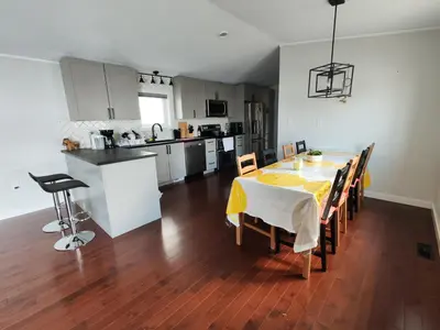 a kitchen and dining room with a table and chairs at EC Lodging in Yellowknife