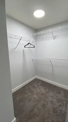 a room with white walls and a ceiling with shelves at Comfortable and centrally located guest suite in Calgary