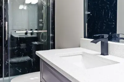 a bathroom with a sink and a shower at Executive Bliss Suites in Calgary