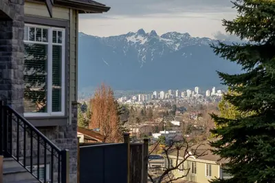 a view of a city with a mountain in the background at Modern West Coast Contemporary Suite in Vancouver
