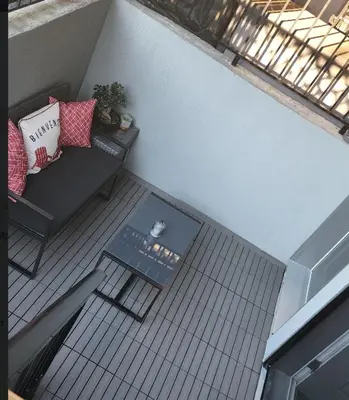 an overhead view of a balcony with a couch and a table at Modern West Coast Contemporary Suite in Vancouver