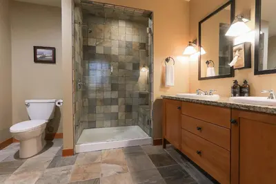 a bathroom with a shower and a toilet and a sink at Slalom Creek 3 Bedrooms in Rossland