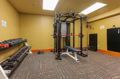 a room with a gym with weights at Slalom Creek 3 Bedroom in Rossland