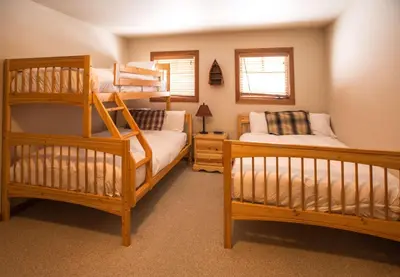a bedroom with two bunk beds and a ladder at White Wolf in Rossland