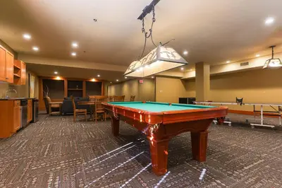 a pool table in the middle of a room at Slalom Creek 2 Bedroom & Den in Rossland