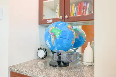 a globe sitting on top of a counter with a clock at Vancouver Getaway in Vancouver
