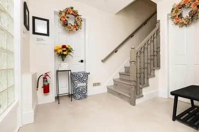 a hallway with stairs and a wreath on the wall at Vancouver Getaway in Vancouver