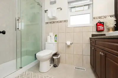 a bathroom with a toilet and a glass shower at Vancouver Getaway in Vancouver