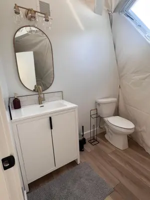a bathroom with a sink and a toilet and a mirror at Experience Luxury Glamping at Ravines Edge Geo Glamping in Devon