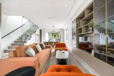 a living room with a couch and chairs and stairs at Charming and Modern Retreat in Vancouver Trendy 42nd Avenue Neighbourhood in Vancouver