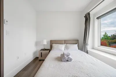 a bedroom with a bed with two stuffed animals on it at Charming and Modern Retreat in Vancouver Trendy 42nd Avenue Neighbourhood in Vancouver