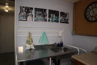 a kitchen counter with a sink and a clock at Calgary's Home Cinema Retreat in Calgary