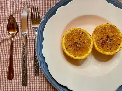 a plate with two orange slices on a table at Hummingbird Gardens B&B in Ladysmith
