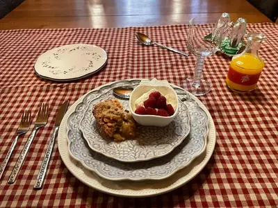 a table with a plate of food and a bowl of fruit at Hummingbird Gardens B&B in Ladysmith