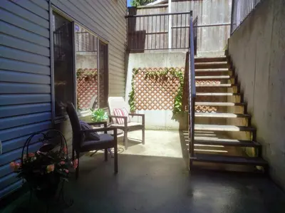 a stairway with two chairs and a table on a house at Angela's Private Suites in Surrey