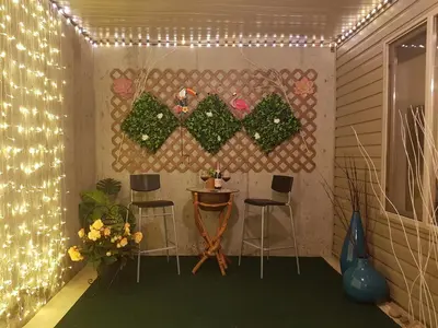 a patio with a table and chairs and lights at Angela's Private Suites in Surrey