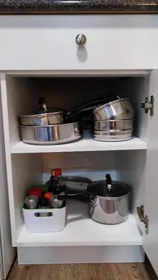 two pots and pans in a kitchen drawer at Angela's Private Suites in Surrey