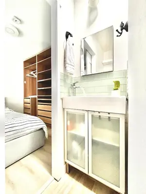 a bathroom with a sink and a bed in a room at Cozy 3BR Holiday Retreat 2 Free Parking AC King BD in Vancouver