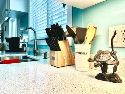 a kitchen counter with a container of utensils at Cozy 3BR Holiday Retreat 2 Free Parking AC King BD in Vancouver