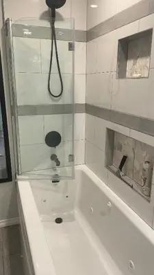 a bathroom with a bath tub with a shower at Trader Vics Tiki Bar n Grill in Nanaimo