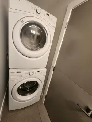 a washer and dryer in a small room at Cozy Royal Bay Suite in Victoria