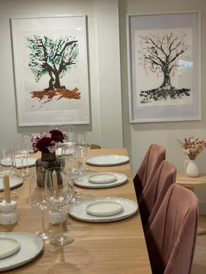 a dining room table with plates and wine glasses at Almost Home in West Vancouver