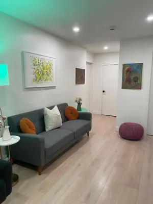 a living room with a blue couch in a room at Almost Home in West Vancouver