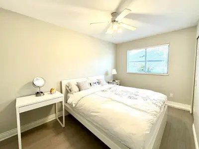 a bedroom with a bed and a ceiling fan at Newly renovated 2 bed 1 bath in Ladner BC in Delta